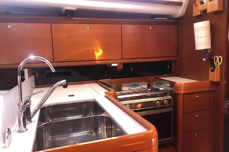 Perseverance Yacht Photos Pics Luxurious kitchen interior of 2012 Grand Soleil 43 yacht with wooden cabinets and stainless steel sink.