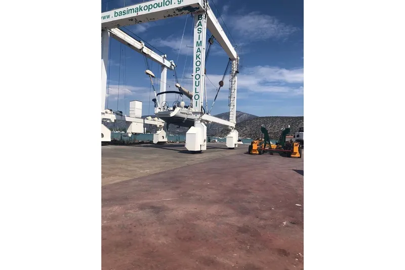 Perseverance Yacht Photos Pics Boat lift at a marina with a Grand Soleil 43 yacht, 2012 model, under clear skies.