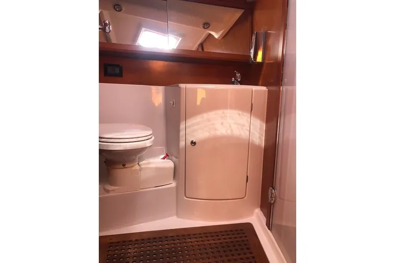 Perseverance Yacht Photos Pics Bathroom interior of 2012 Grand Soleil 43 yacht, featuring toilet and wooden accents.
