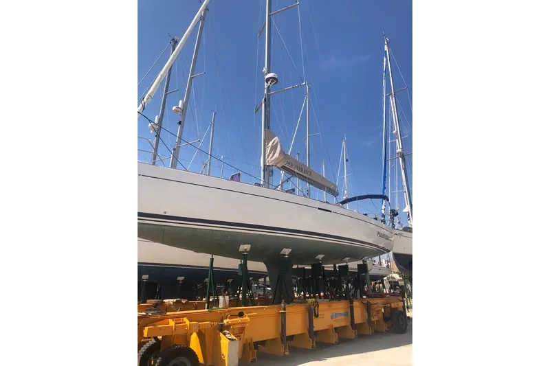 Perseverance Yacht Photos Pics 2012 Grand Soleil 43 sailboat on a trailer in a marina, under clear blue skies.