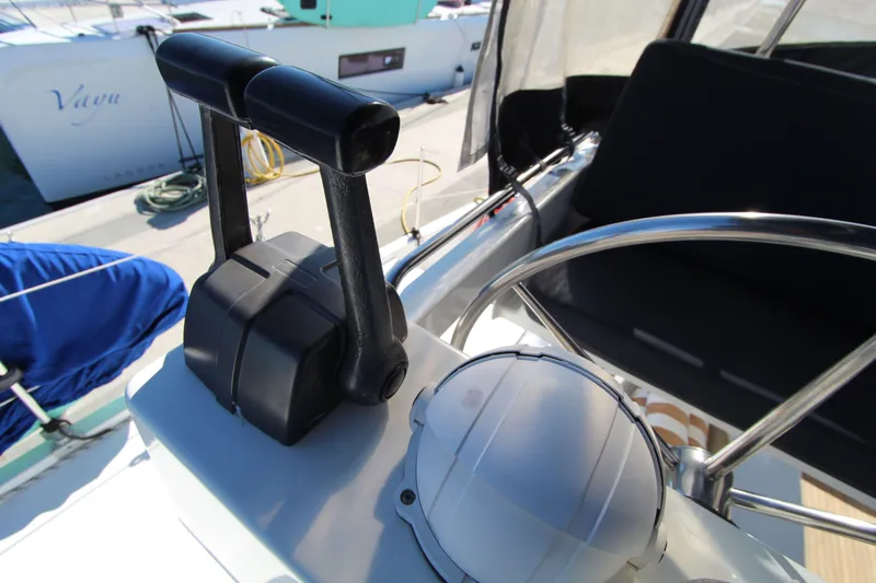  Yacht Photos Pics Helm station of 2013 Fountaine Pajot Helia 44 catamaran with throttle controls and steering wheel.