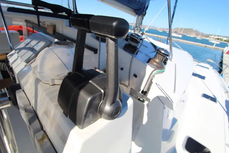  Yacht Photos Pics Close-up of 2013 Fountaine Pajot Helia 44 yacht controls with marina background.