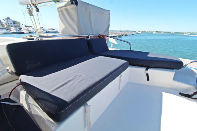  Yacht Photos Pics Fountaine Pajot Helia 44 catamaran deck with cushioned seating, 2013 model, marina view.