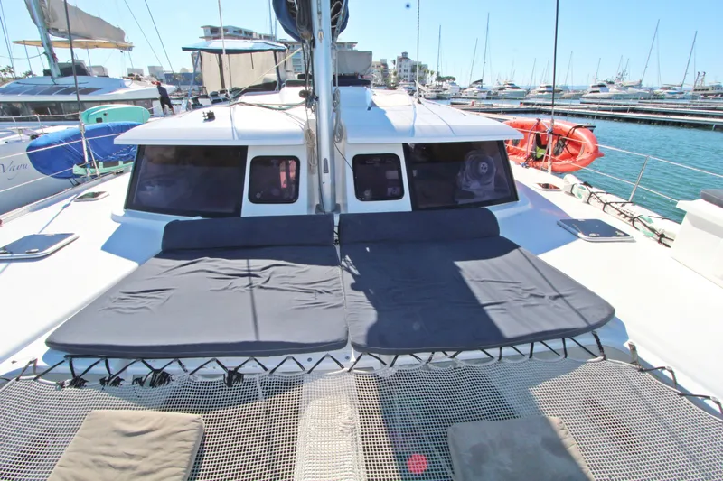  Yacht Photos Pics 2013 Fountaine Pajot Helia 44 catamaran docked in marina, featuring spacious deck and netting.