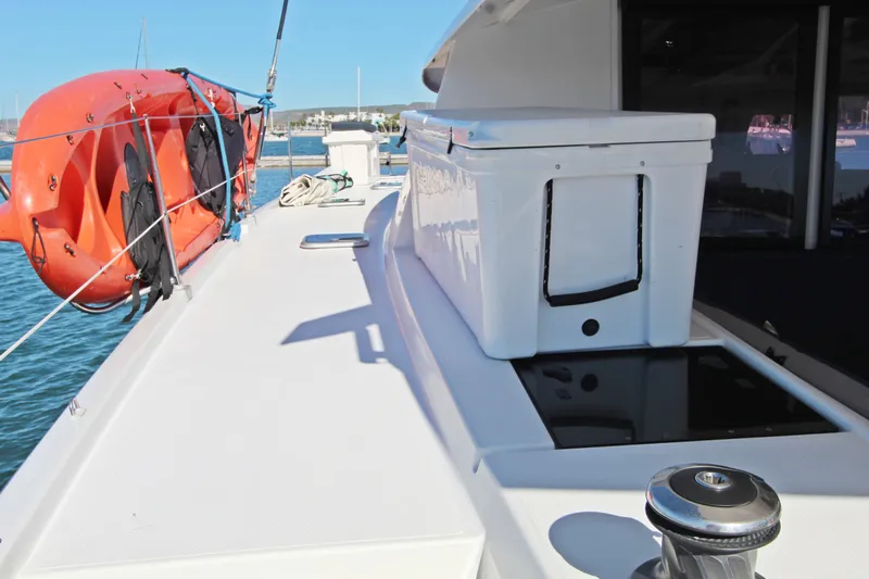 Yacht Photos Pics Deck of 2013 Fountaine Pajot Helia 44 catamaran with orange kayak and storage box.