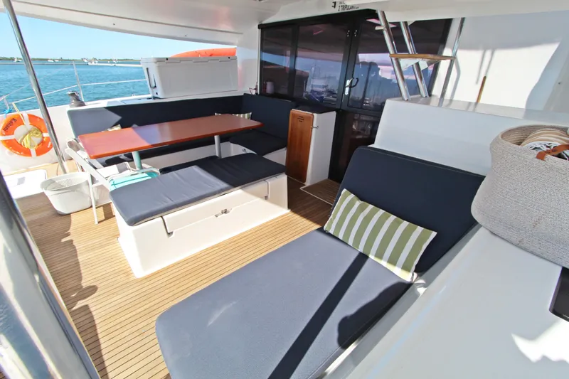  Yacht Photos Pics Spacious deck of 2013 Fountaine Pajot Helia 44 catamaran with seating and table.