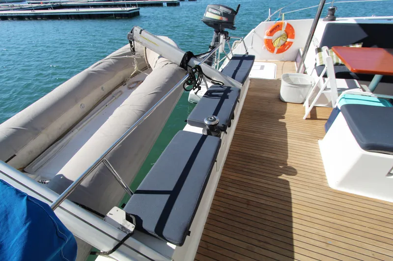  Yacht Photos Pics Fountaine Pajot Helia 44 catamaran deck with seating, dinghy, and outboard motor, 2013 model.