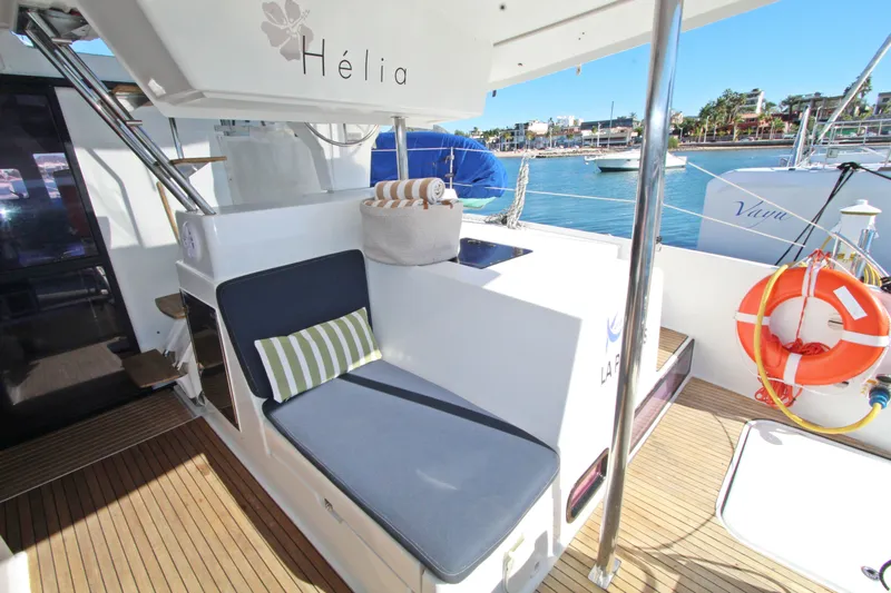  Yacht Photos Pics 2013 Fountaine Pajot Helia 44 yacht deck with seating, lifebuoy, and marina view.