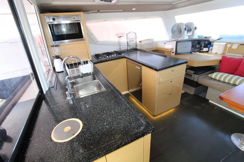  Yacht Photos Pics Modern kitchen interior of 2013 Fountaine Pajot Helia 44 catamaran with sleek countertops and appliances.
