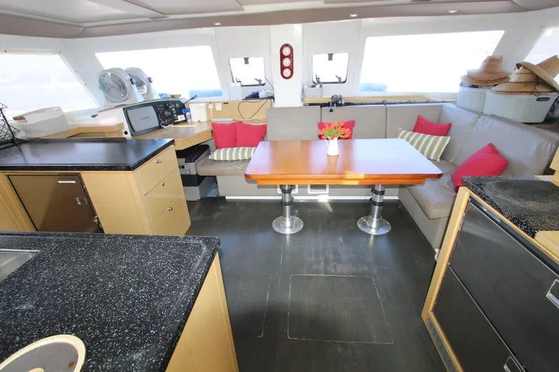  Yacht Photos Pics Interior of 2013 Fountaine Pajot Helia 44 catamaran with modern dining area and navigation station.