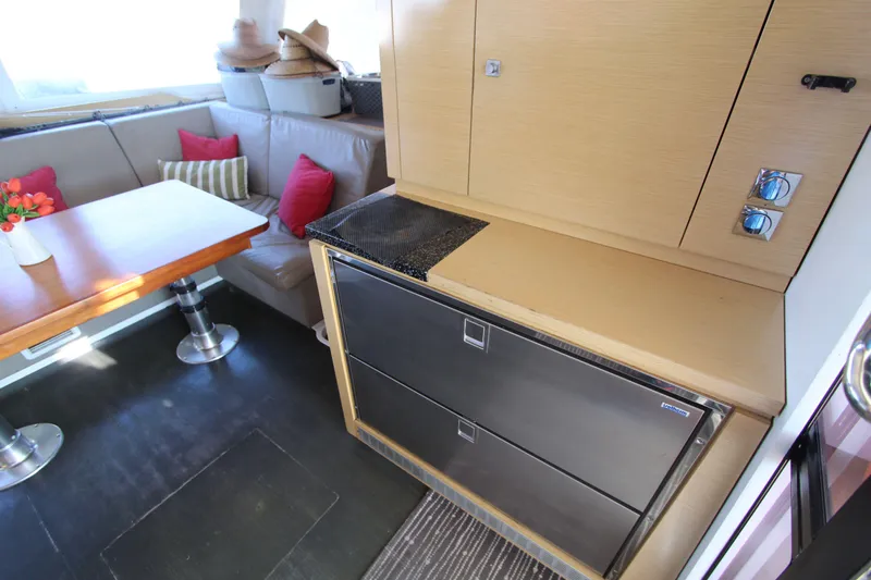  Yacht Photos Pics Interior of 2013 Fountaine Pajot Helia 44 catamaran with dining area and modern cabinetry.