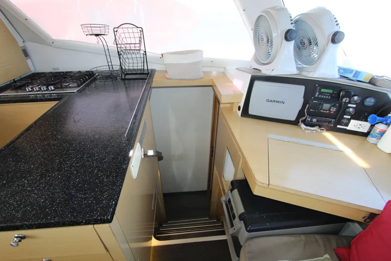  Yacht Photos Pics Interior of 2013 Fountaine Pajot Helia 44 catamaran with kitchen and navigation equipment.