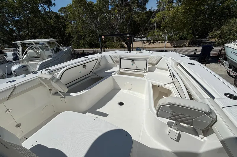 Wcn 57599 325cc Yacht Photos Pics 2025 World Cat 325 CC boat interior with seating and storage, docked outdoors.