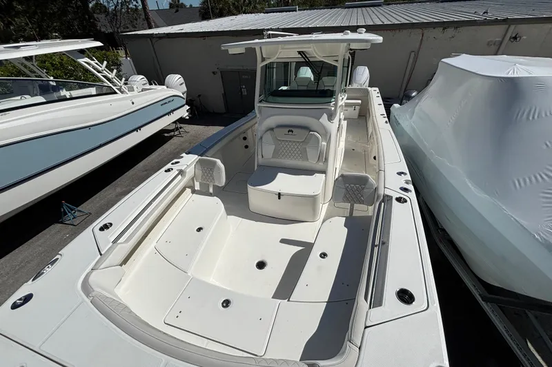 Wcn 57599 325cc Yacht Photos Pics 2025 World Cat 325 CC boat with spacious deck and seating, docked outdoors.