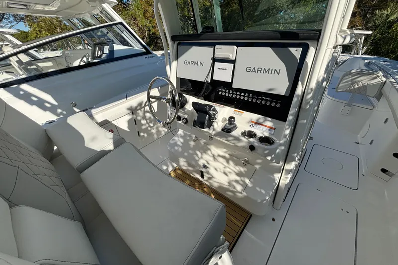 Wcn 57599 325cc Yacht Photos Pics 2025 World Cat 325 CC boat cockpit with Garmin navigation system and luxurious seating.