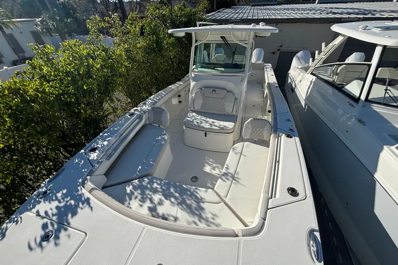 Wcn 57599 325cc Yacht Photos Pics 2025 World Cat 325 CC boat with spacious seating and sleek design, docked outdoors.