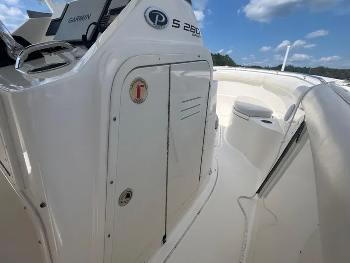  Yacht Photos Pics 2011 Pursuit S 280 Sport boat interior with Garmin equipment, under a clear blue sky.