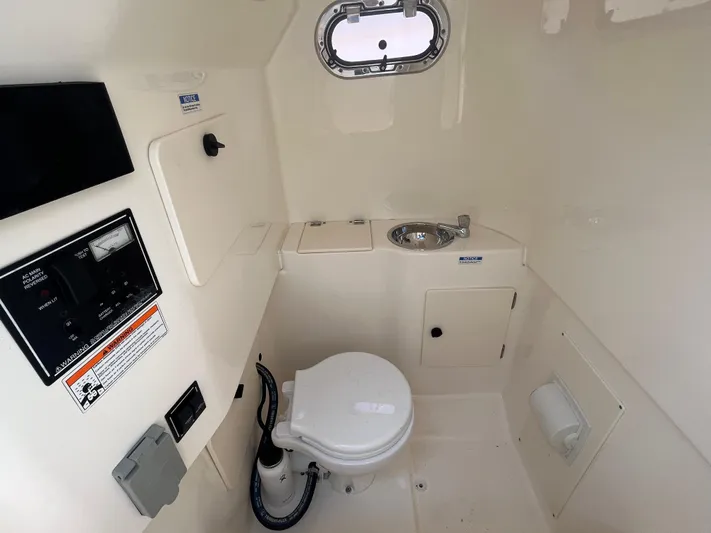  Yacht Photos Pics 2011 Pursuit S 280 Sport boat interior with toilet and sink.