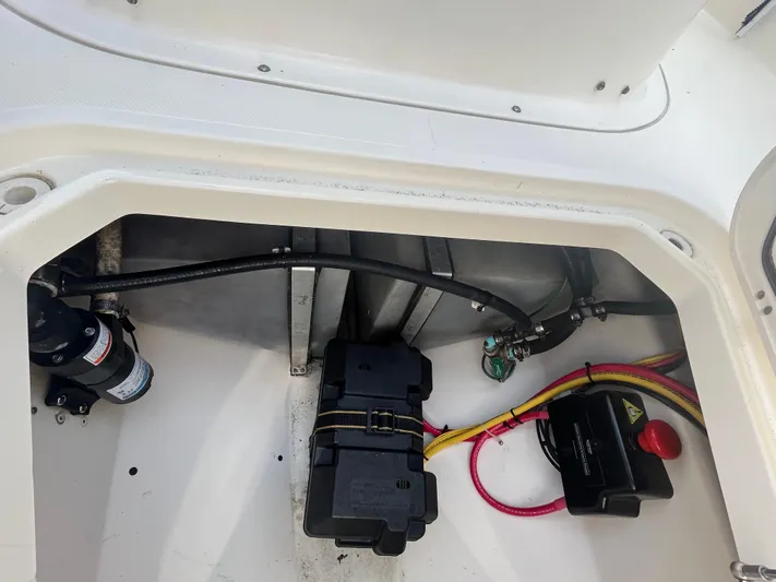  Yacht Photos Pics 2011 Pursuit S 280 Sport boat compartment with wiring and battery components.