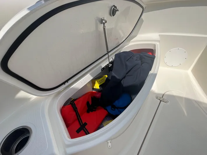  Yacht Photos Pics Open storage compartment on 2011 Pursuit S 280 Sport boat with gear inside.