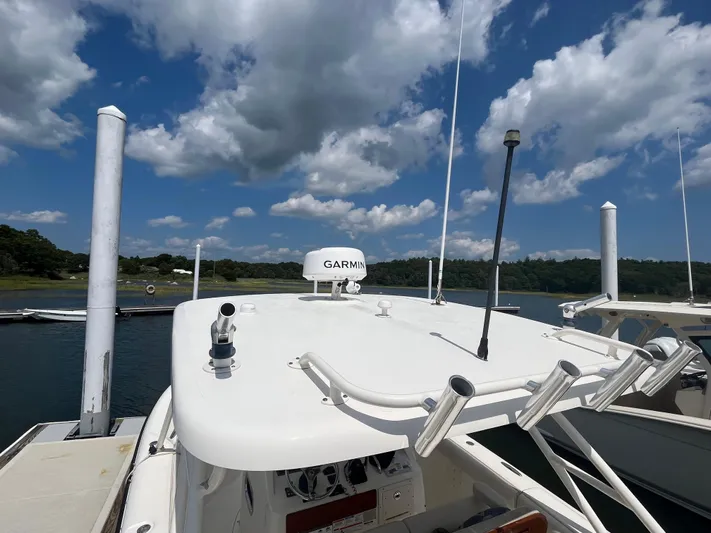  Yacht Photos Pics 2011 Pursuit S 280 Sport boat docked under a cloudy sky.