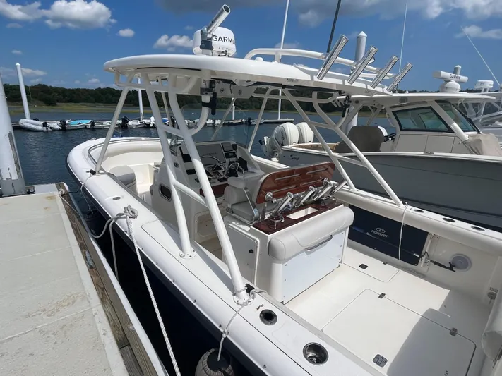  Yacht Photos Pics 2011 Pursuit S 280 Sport boat docked at marina under blue sky.
