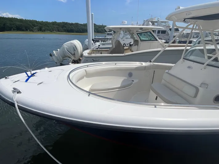  Yacht Photos Pics 2011 Pursuit S 280 Sport boat docked on calm water.