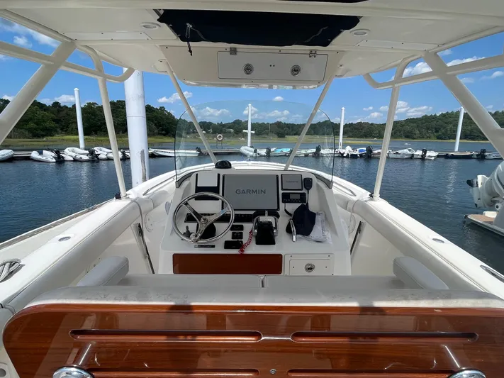  Yacht Photos Pics 2011 Pursuit S 280 Sport boat cockpit with Garmin navigation, docked at a marina.