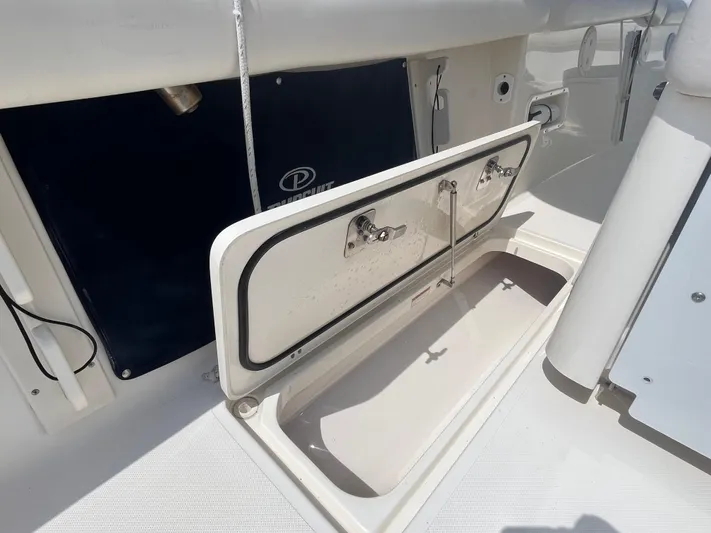 Yacht Photos Pics Open storage compartment on 2011 Pursuit S 280 Sport boat deck.