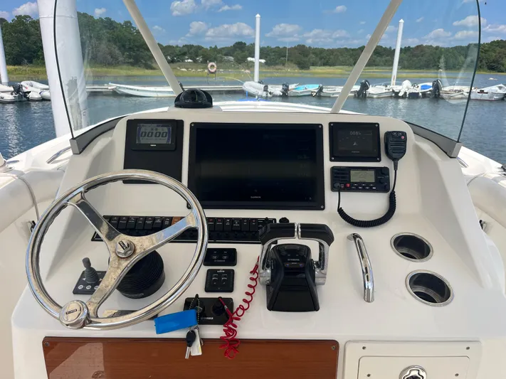  Yacht Photos Pics 2011 Pursuit S 280 Sport boat dashboard with steering wheel and navigation controls.
