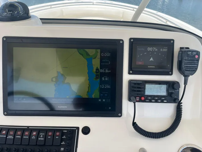  Yacht Photos Pics Boat dashboard with navigation screens and radio on a 2011 Pursuit S 280 Sport.