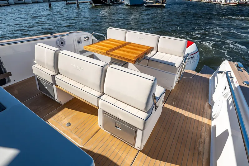Available Now Yacht Photos Pics Luxurious seating area on 2025 Pardo Yachts 38, featuring elegant wooden table and cushioned benches.