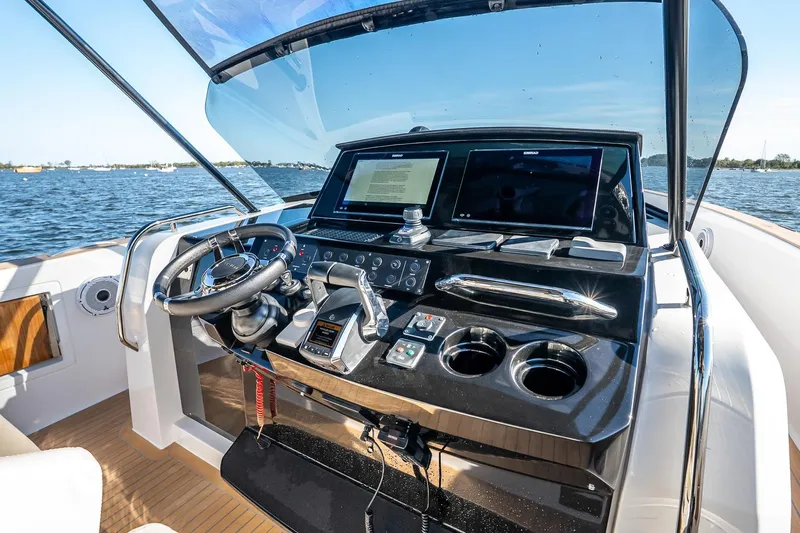 Available Now Yacht Photos Pics Cockpit of 2025 Pardo Yachts 38 with modern controls and dual screens on open water.