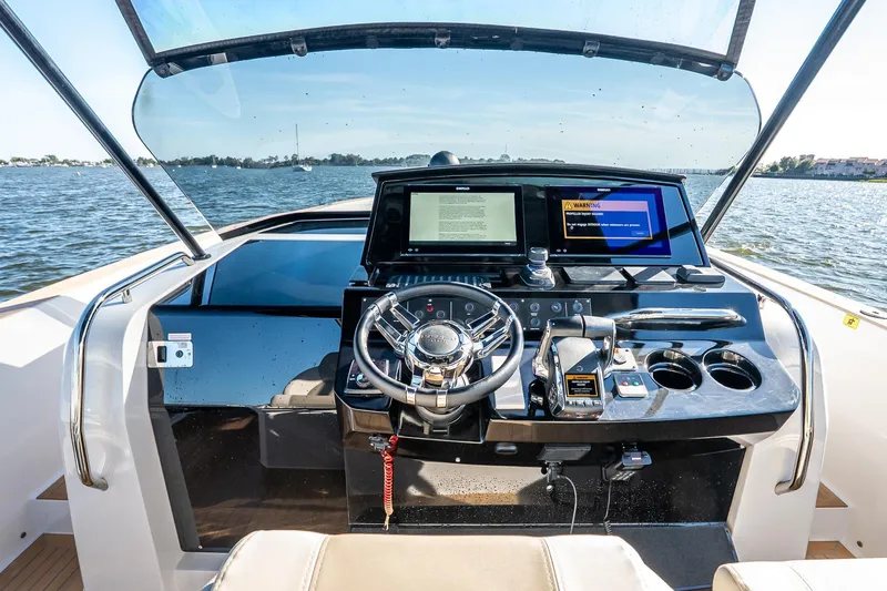 Available Now Yacht Photos Pics 2025 Pardo Yachts 38 helm with modern controls and dual screens on open water.