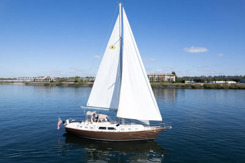 Easy Going Yacht Photos Pics 2008 Island Packet 465 sailboat on calm water under clear blue sky.