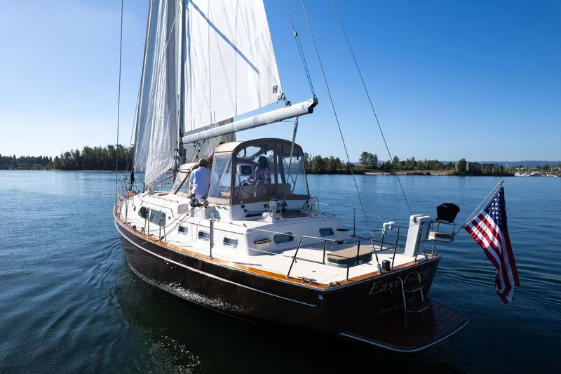 Easy Going Yacht Photos Pics 2008 Island Packet 465 sailboat cruising on calm waters with American flag.
