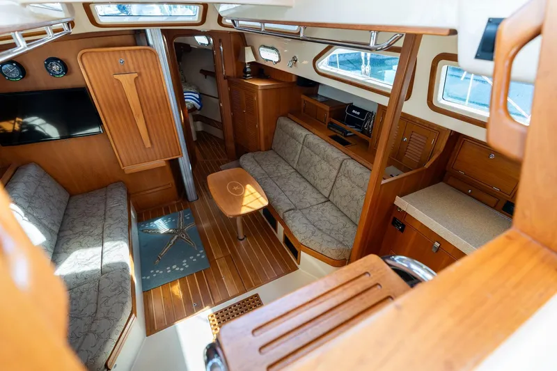 Easy Going Yacht Photos Pics Interior of 2008 Island Packet 465 yacht with cozy seating and wooden finishes.
