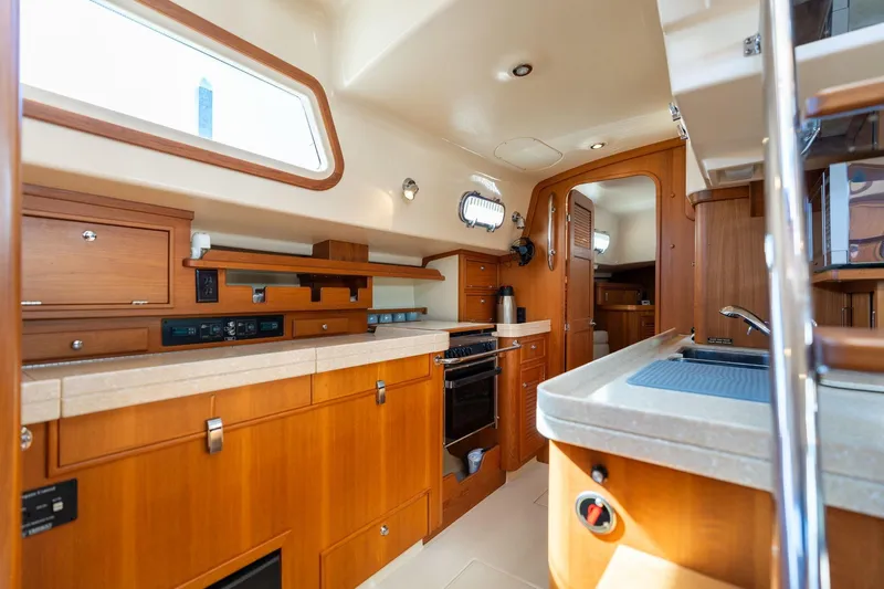 Easy Going Yacht Photos Pics Luxurious 2008 Island Packet 465 yacht interior with modern kitchen and wooden cabinetry.