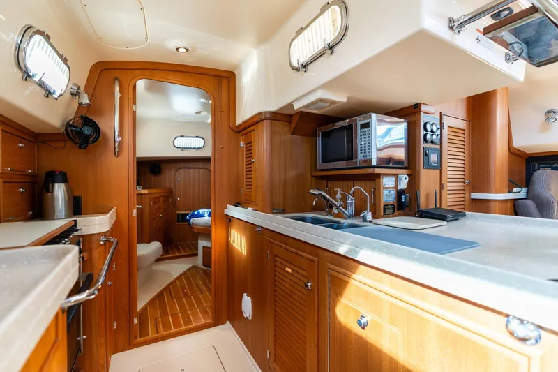 Easy Going Yacht Photos Pics Luxurious 2008 Island Packet 465 yacht interior with modern kitchen and cozy cabin.