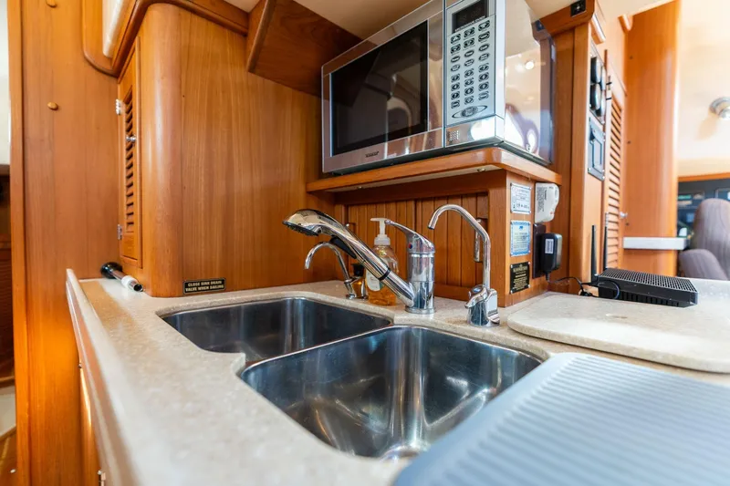 Easy Going Yacht Photos Pics Luxurious 2008 Island Packet 465 yacht kitchen with stainless steel sink and microwave.