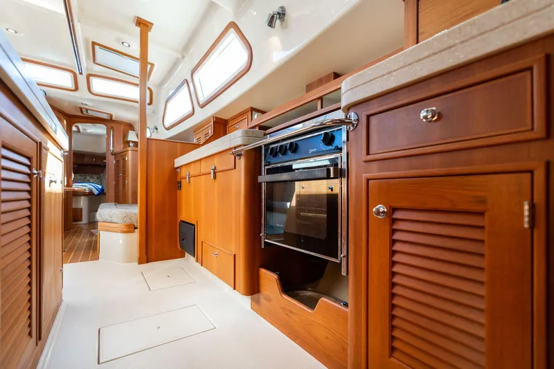 Easy Going Yacht Photos Pics Interior of 2008 Island Packet 465 yacht, featuring a well-equipped kitchen and cozy living space.