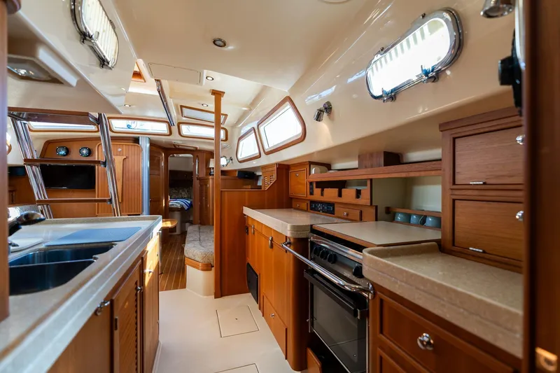 Easy Going Yacht Photos Pics Luxurious interior of 2008 Island Packet 465 yacht with modern kitchen and wood finishes.