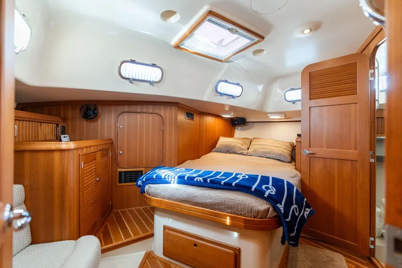 Easy Going Yacht Photos Pics Luxurious 2008 Island Packet 465 yacht cabin with cozy bed and elegant wood finish.