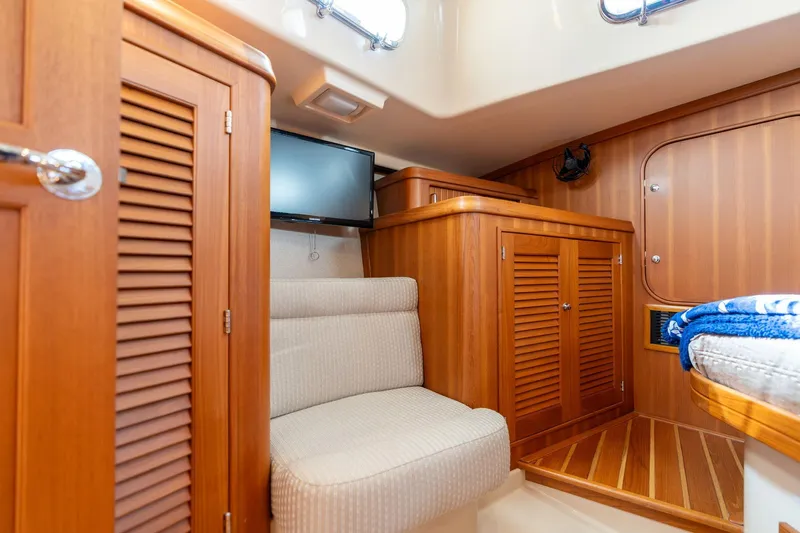 Easy Going Yacht Photos Pics Interior of 2008 Island Packet 465 yacht with wooden cabinetry and seating area.