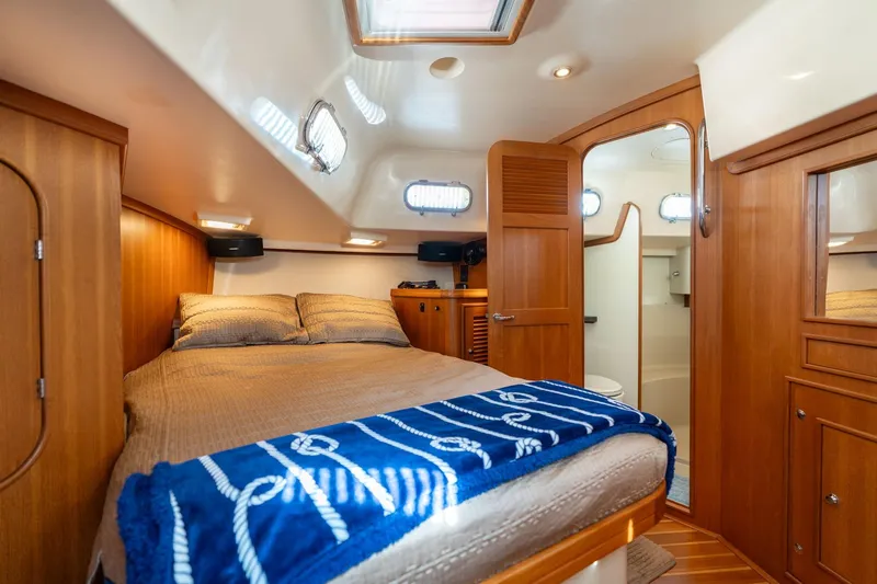 Easy Going Yacht Photos Pics Luxurious cabin interior of 2008 Island Packet 465 yacht with cozy bed and wooden finish.
