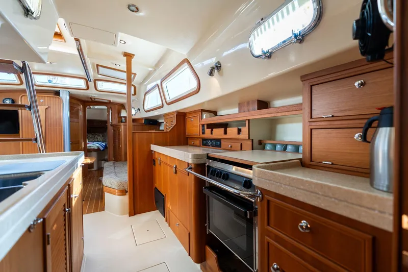 Easy Going Yacht Photos Pics Luxurious interior of 2008 Island Packet 465 yacht with modern kitchen and cozy seating.