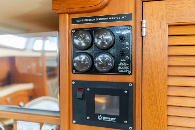 Easy Going Yacht Photos Pics Control panel on 2008 Island Packet 465 yacht, featuring gauges and warning labels.
