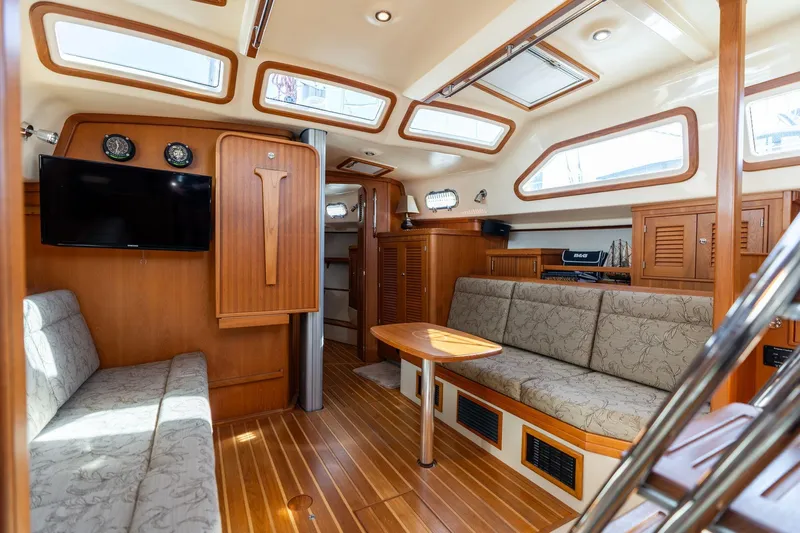Easy Going Yacht Photos Pics Luxurious interior of 2008 Island Packet 465 yacht with elegant wood finish and comfortable seating.