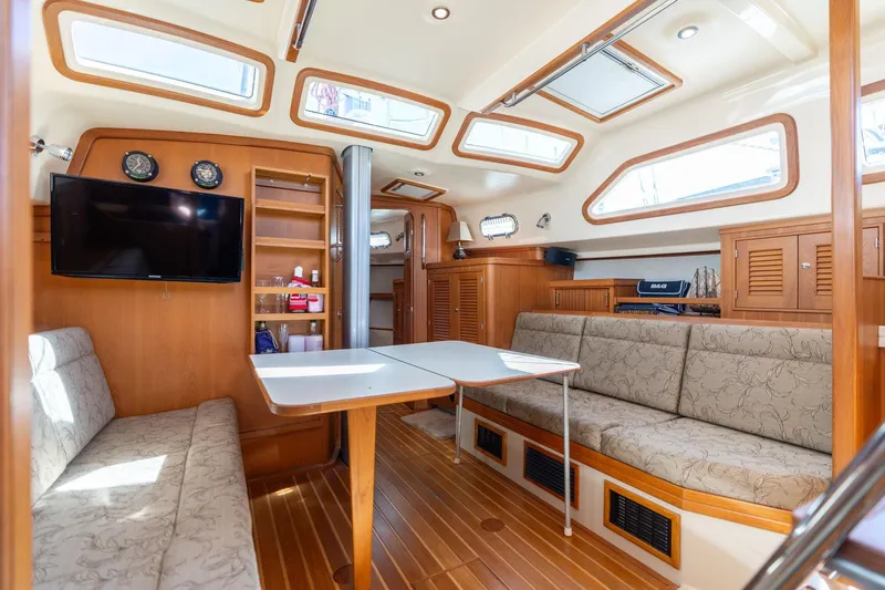 Easy Going Yacht Photos Pics Luxurious 2008 Island Packet 465 yacht interior with seating, table, and entertainment system.