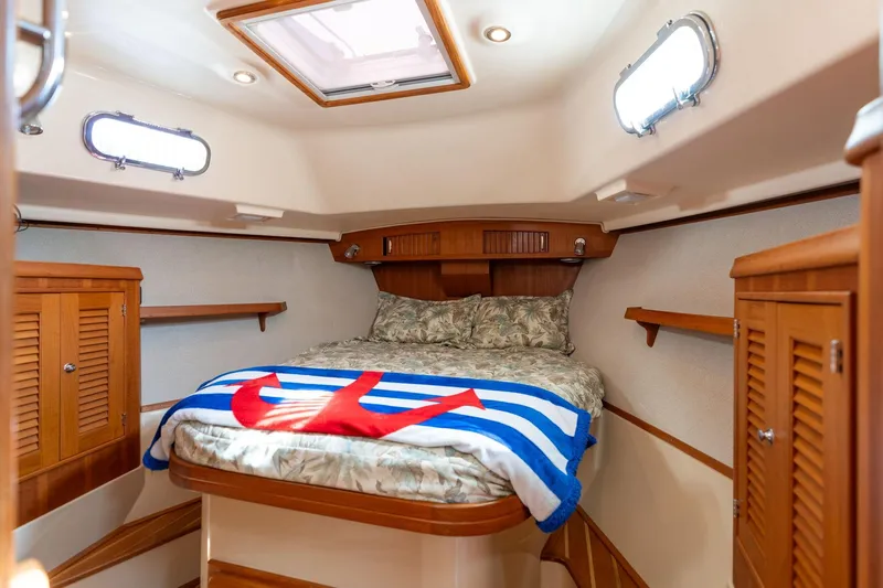 Easy Going Yacht Photos Pics Cozy cabin interior of 2008 Island Packet 465 sailboat with bed and wooden cabinetry.